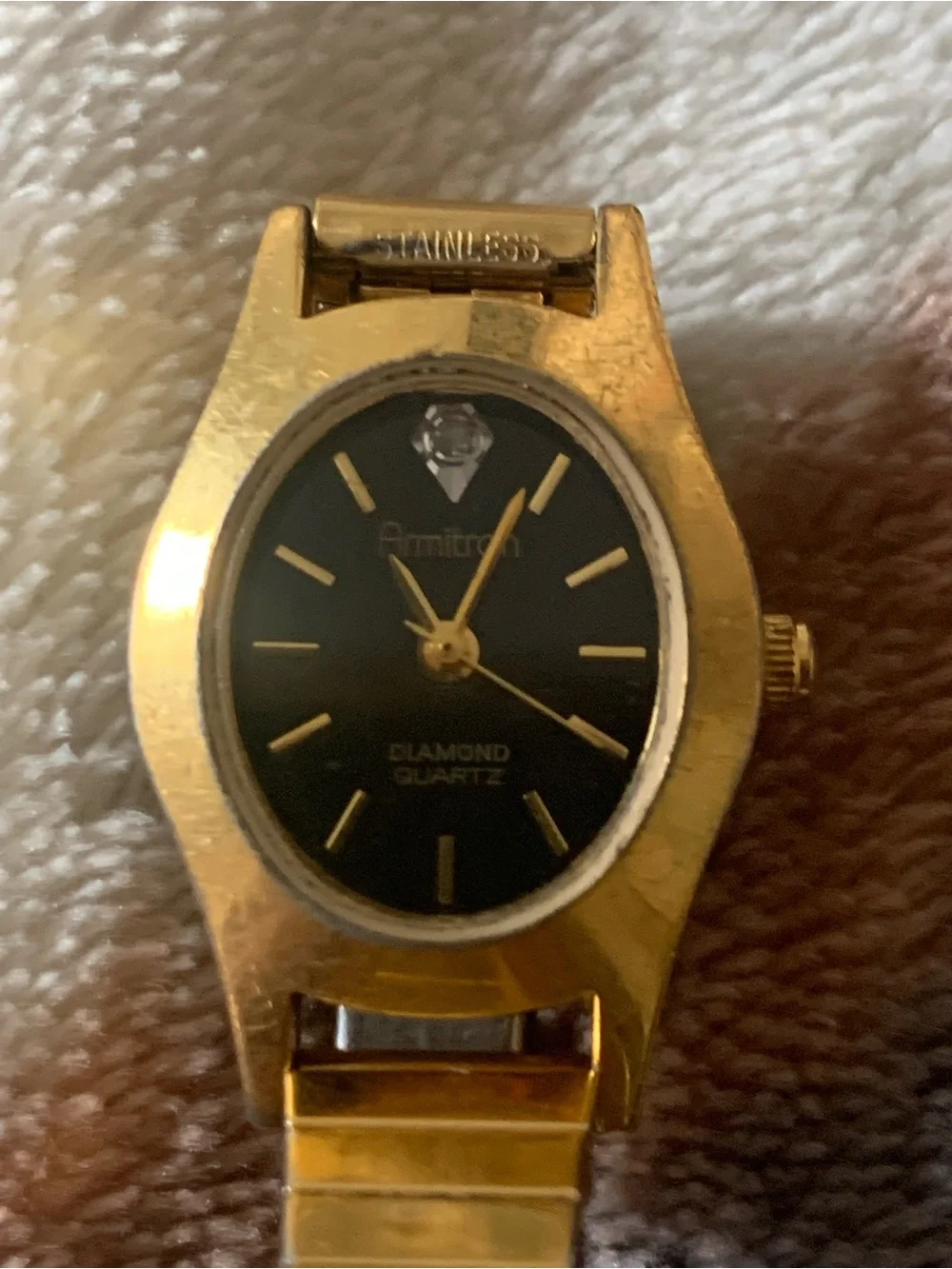 Armitron gold tone with black dial womens watch on stretch bracelet